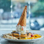 Ice Cream Cone Pancake Stack with Fresh Fruits and Chocolate Drizzle