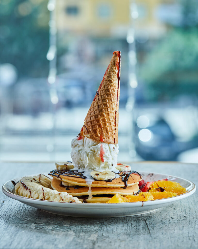 Ice Cream Cone Pancake Stack with Fresh Fruits and Chocolate Drizzle